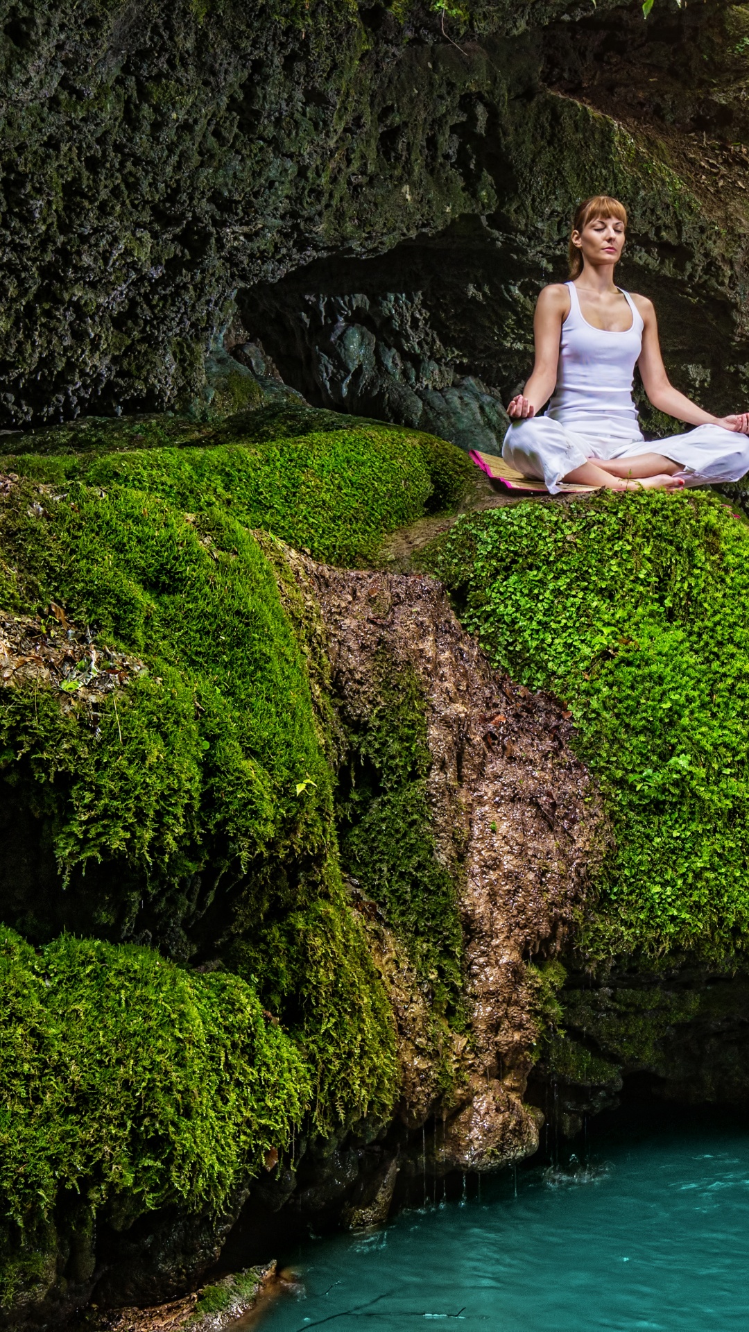 Woman in White Tank Top and Black Pants Sitting on Rock Near Waterfalls During Daytime. Wallpaper in 1080x1920 Resolution