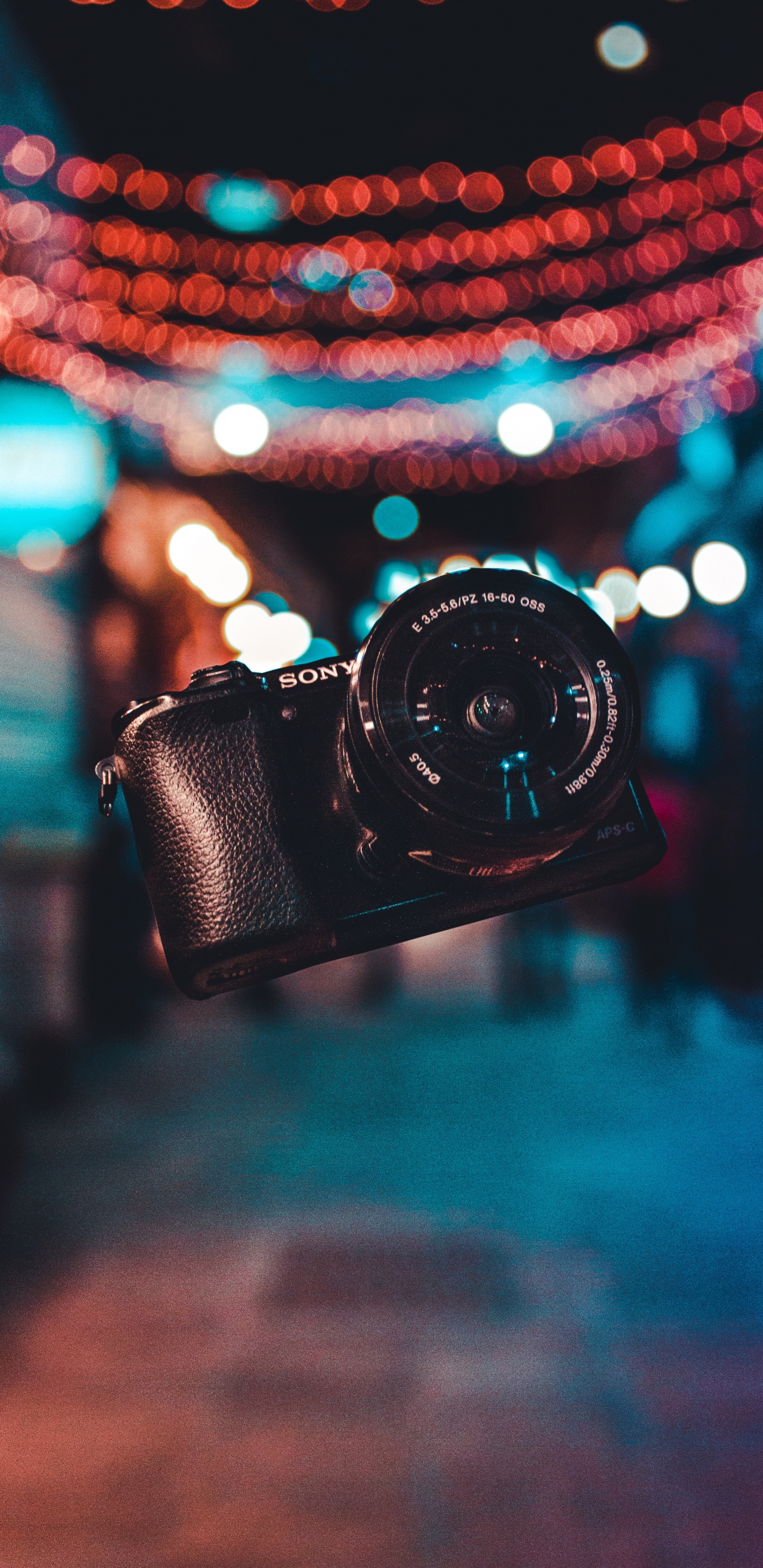 Black Dslr Camera on Blue and White String Lights. Wallpaper in 1440x2960 Resolution