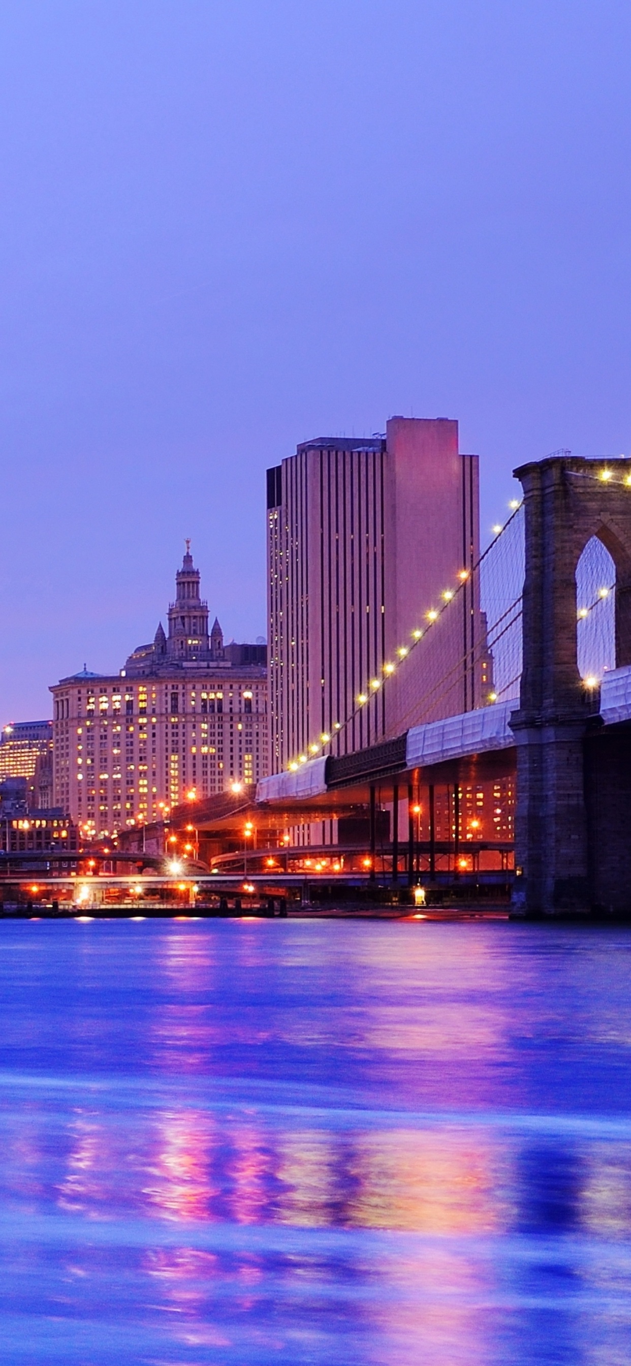 Bridge Over Water During Night Time. Wallpaper in 1242x2688 Resolution