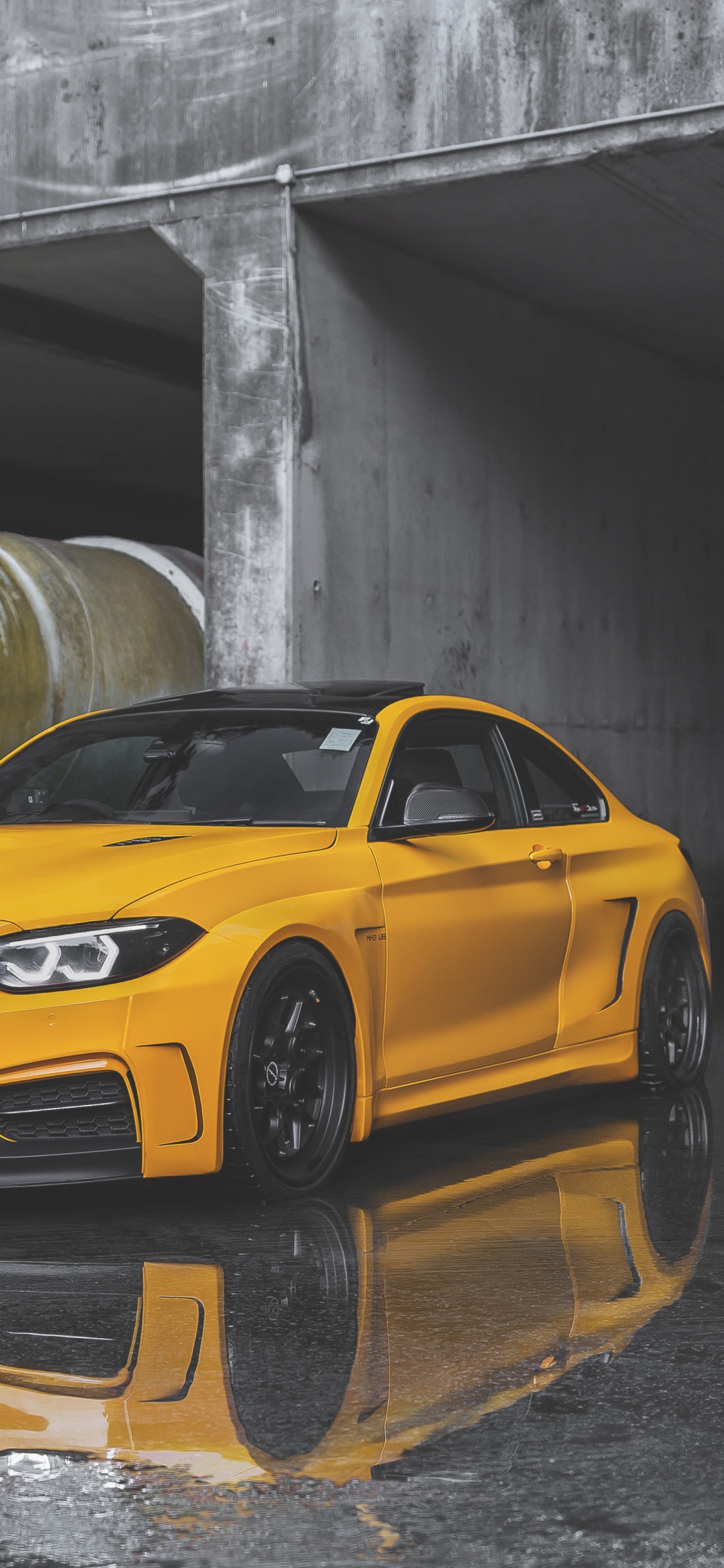 Yellow Chevrolet Camaro Parked in Garage. Wallpaper in 1125x2436 Resolution