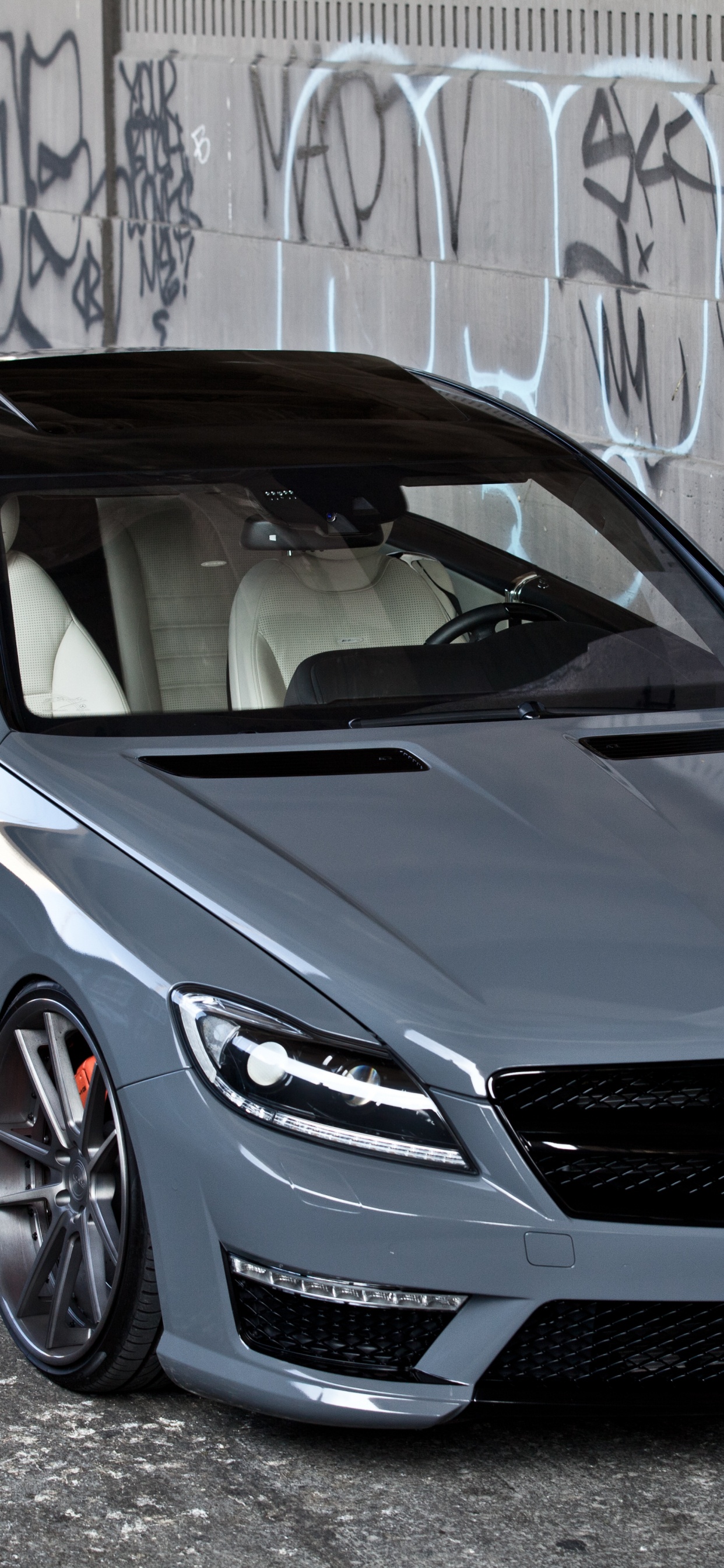 Blue Bmw m 3 Coupe Parked Beside Wall. Wallpaper in 1242x2688 Resolution