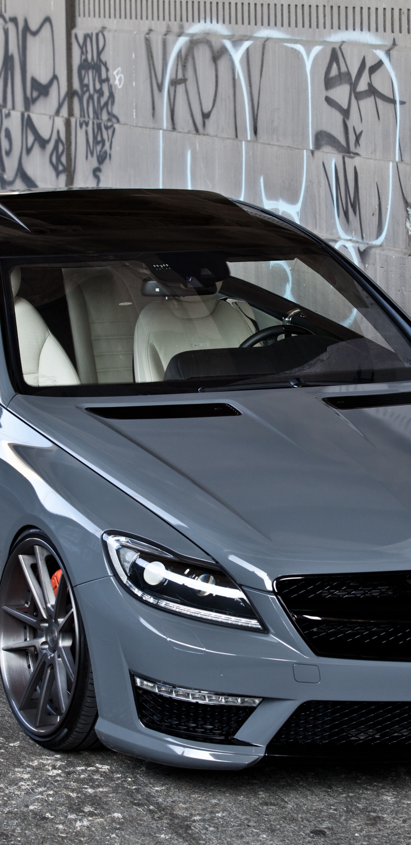 Blue Bmw m 3 Coupe Parked Beside Wall. Wallpaper in 1440x2960 Resolution