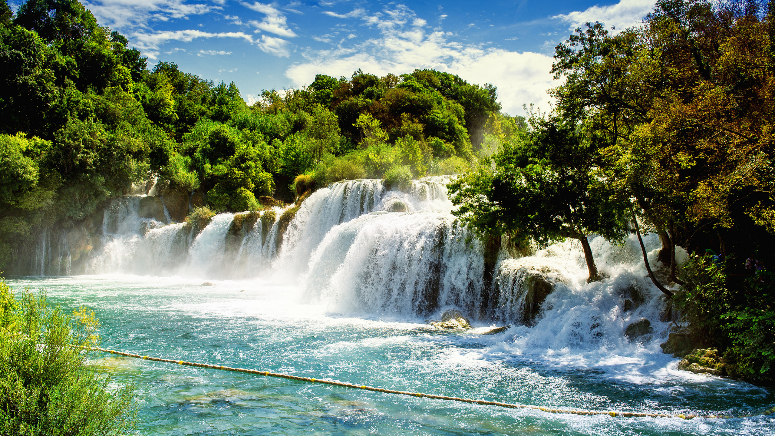 Waterfalls Near Green Trees Under Blue Sky During Daytime. Wallpaper in 2560x1440 Resolution