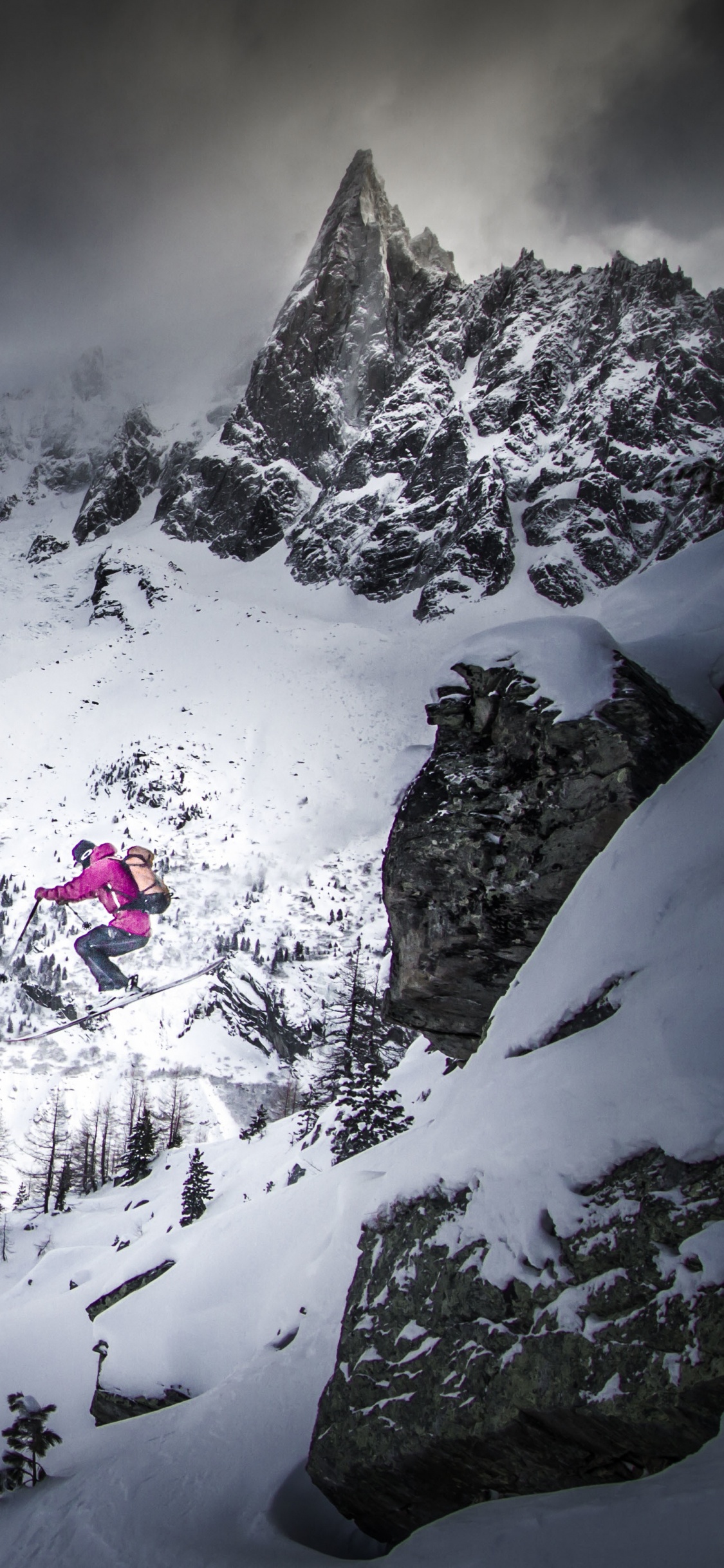 Snow Covered Mountain Under Cloudy Sky. Wallpaper in 1125x2436 Resolution