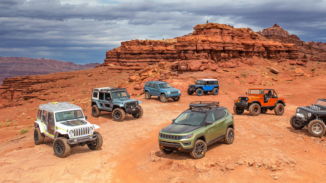 Black Jeep Wrangler on Brown Rocky Mountain During Daytime. Wallpaper in 1366x768 Resolution