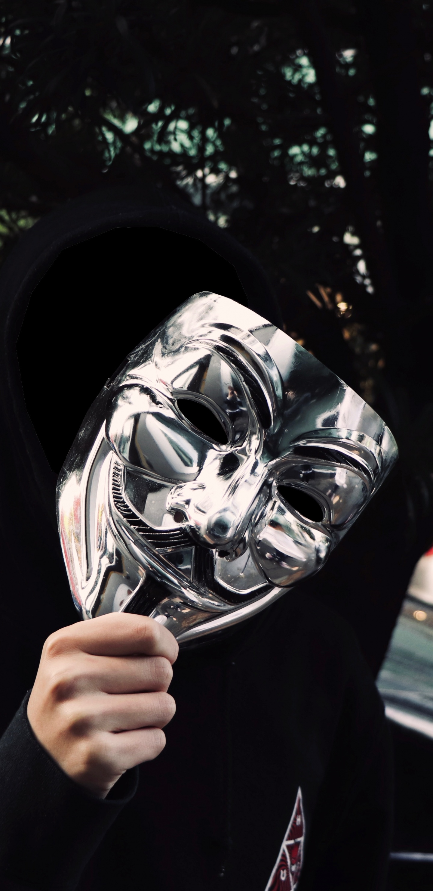 Person in Black Jacket Holding Black and White Mask. Wallpaper in 1440x2960 Resolution