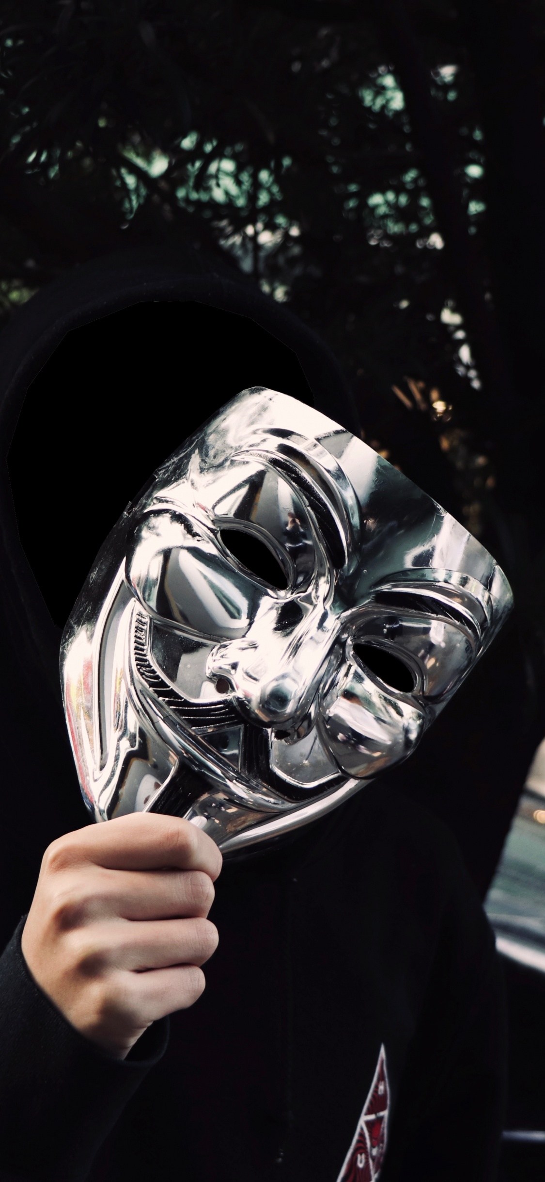 Persona Con Chaqueta Negra Con Máscara en Blanco y Negro. Wallpaper in 1125x2436 Resolution