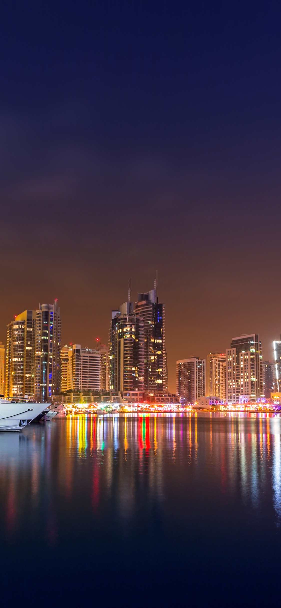 City Skyline During Night Time. Wallpaper in 1125x2436 Resolution