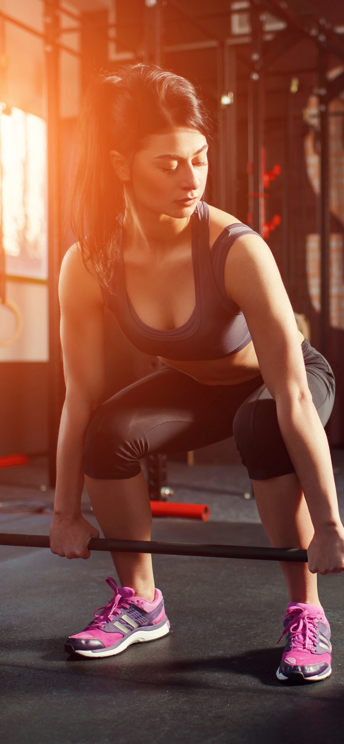 Woman in Black Tank Top and Black Leggings Doing Exercise. Wallpaper in 1125x2436 Resolution