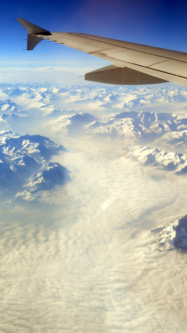 White Clouds Over Snow Covered Mountains During Daytime. Wallpaper in 750x1334 Resolution