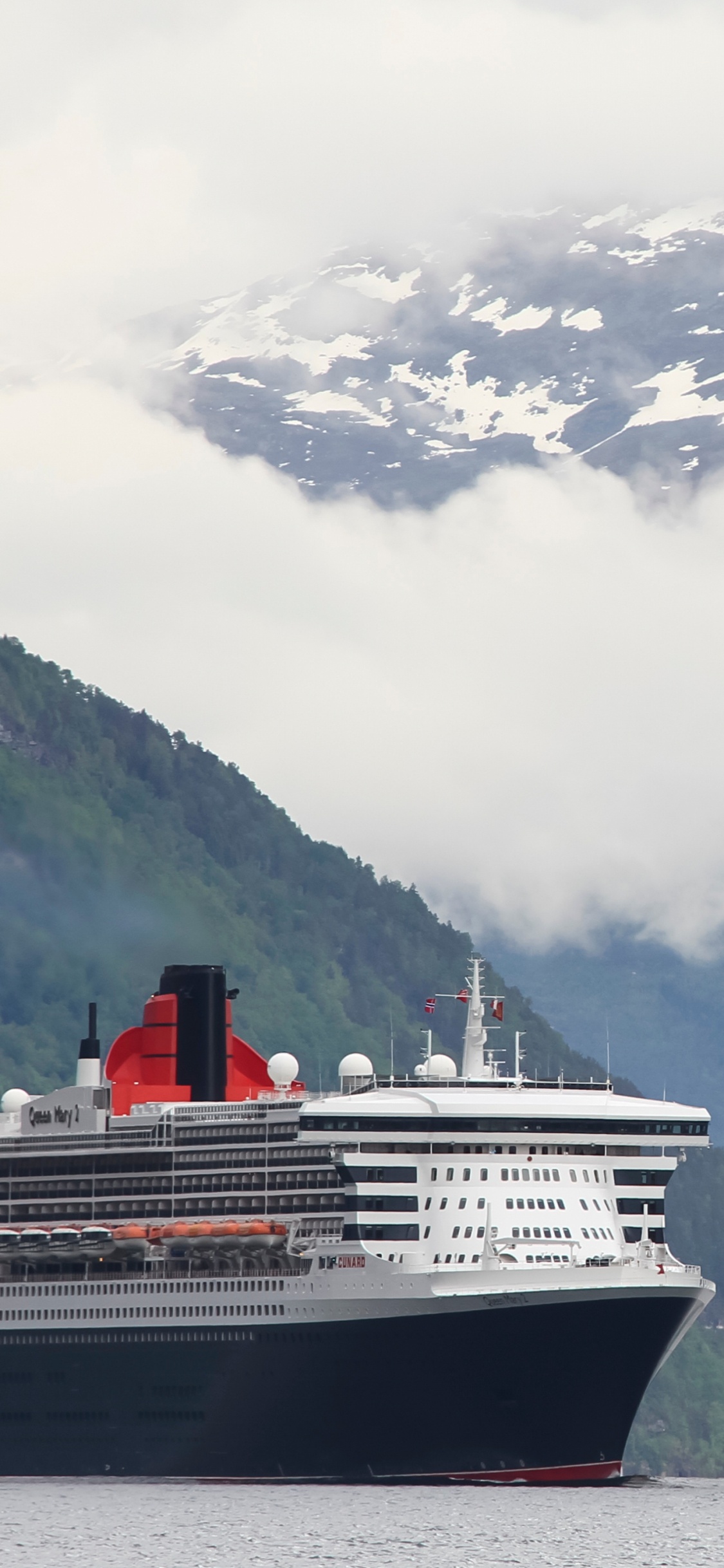 White and Blue Ship on Water Near Mountain During Daytime. Wallpaper in 1125x2436 Resolution