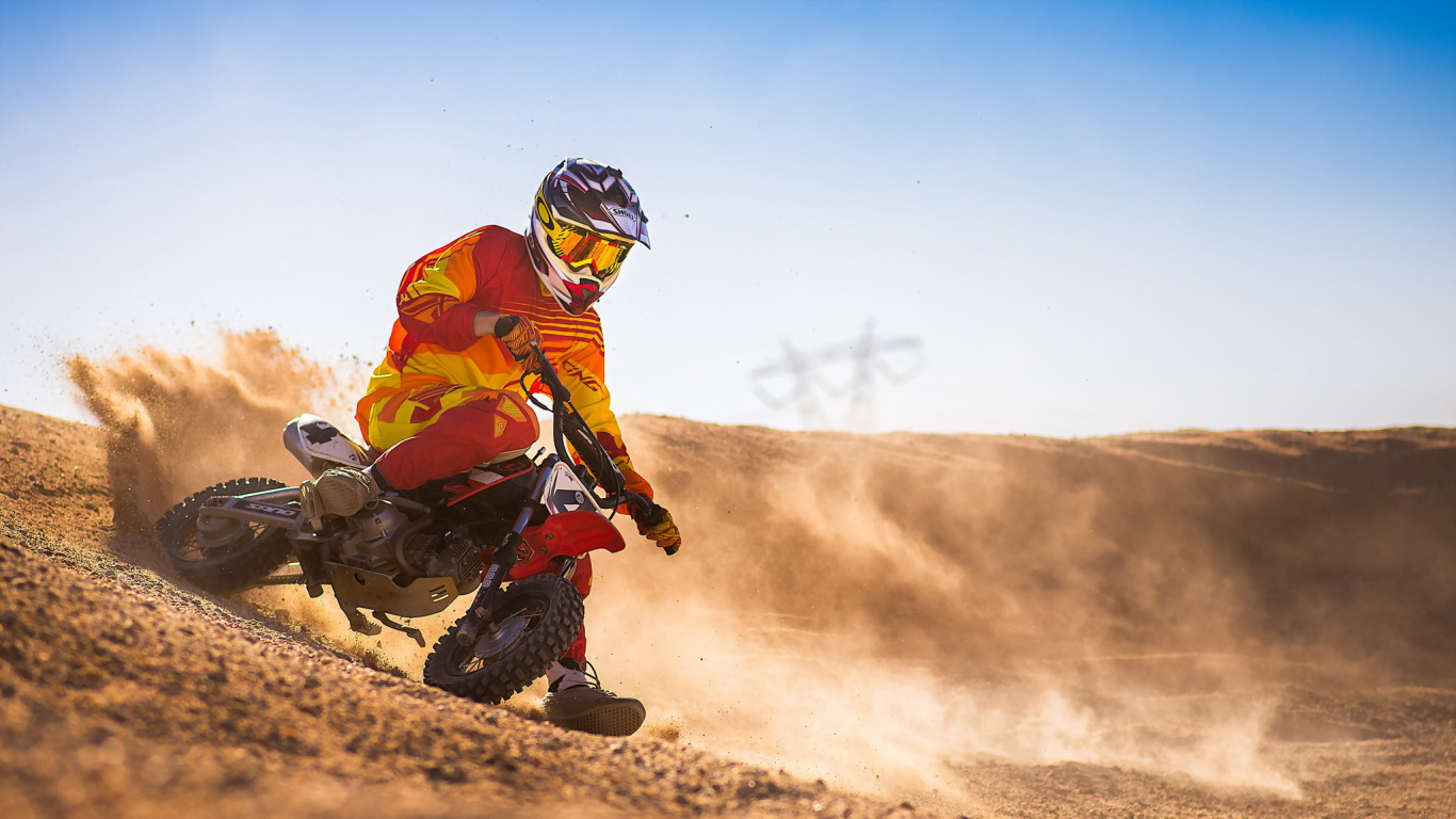 Man in Orange Jacket Riding Motorcycle on Dirt Road During Daytime. Wallpaper in 1366x768 Resolution