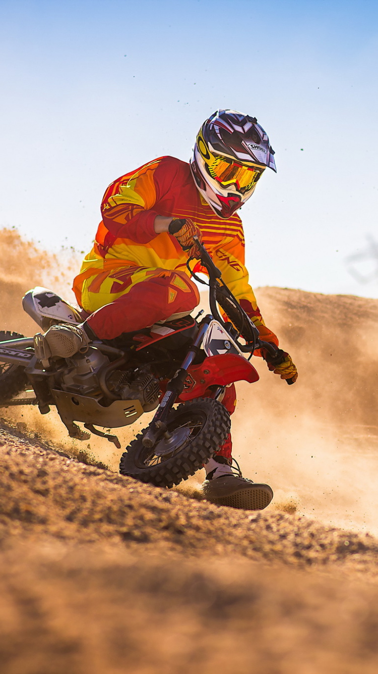 Man in Orange Jacket Riding Motorcycle on Dirt Road During Daytime. Wallpaper in 750x1334 Resolution