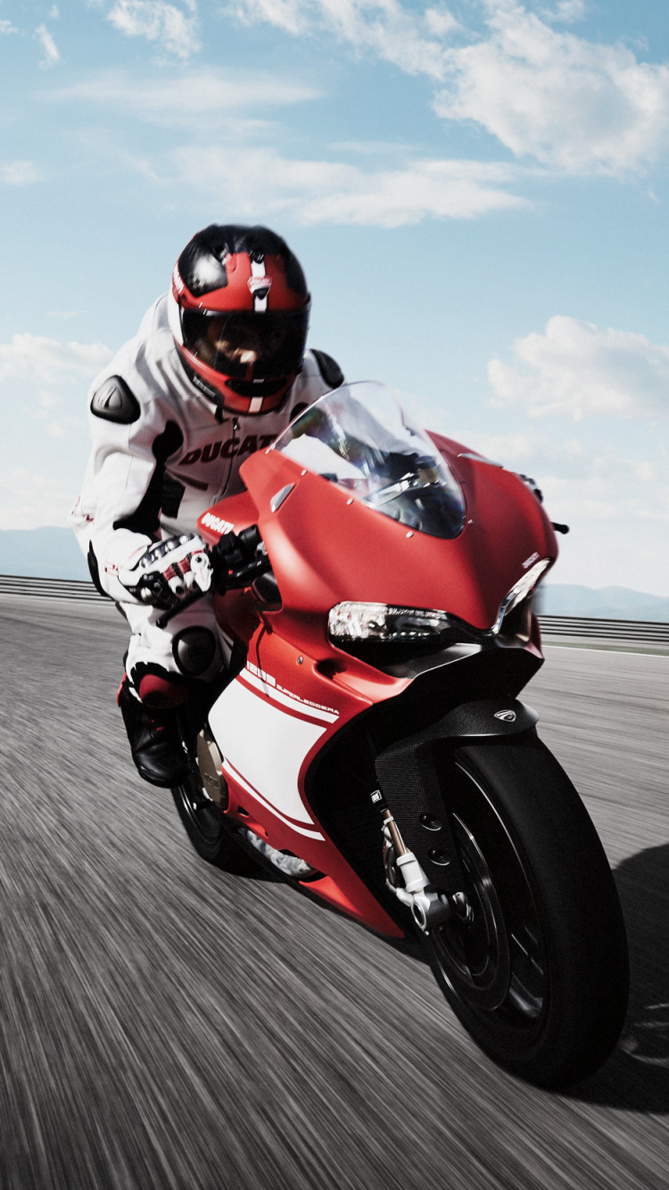 Man in Orange and Black Motorcycle Suit Riding on Red and White Sports Bike. Wallpaper in 750x1334 Resolution
