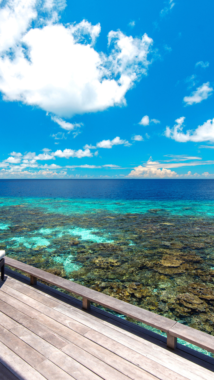 Brown Wooden Dock on Blue Sea Under Blue Sky During Daytime. Wallpaper in 750x1334 Resolution