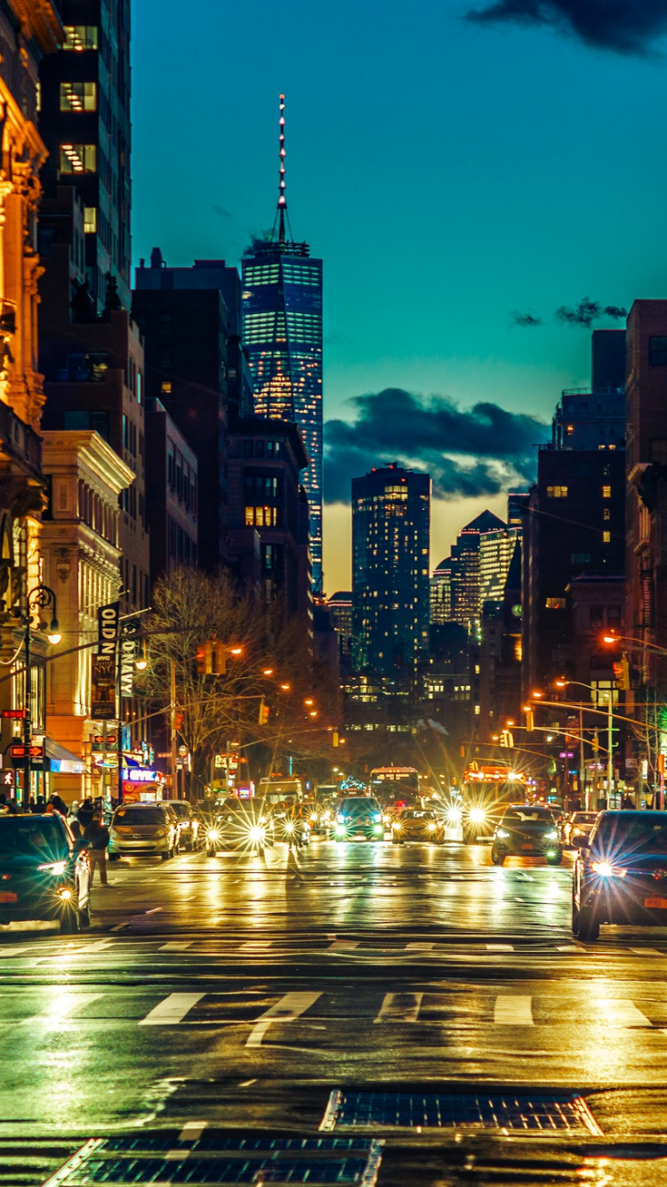 Cars on Road Between High Rise Buildings During Night Time. Wallpaper in 750x1334 Resolution