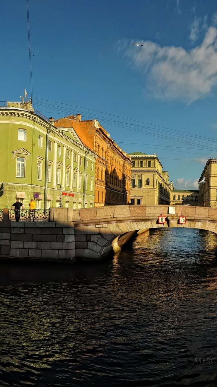 Brown Concrete Building Near River Under Blue Sky During Daytime. Wallpaper in 720x1280 Resolution