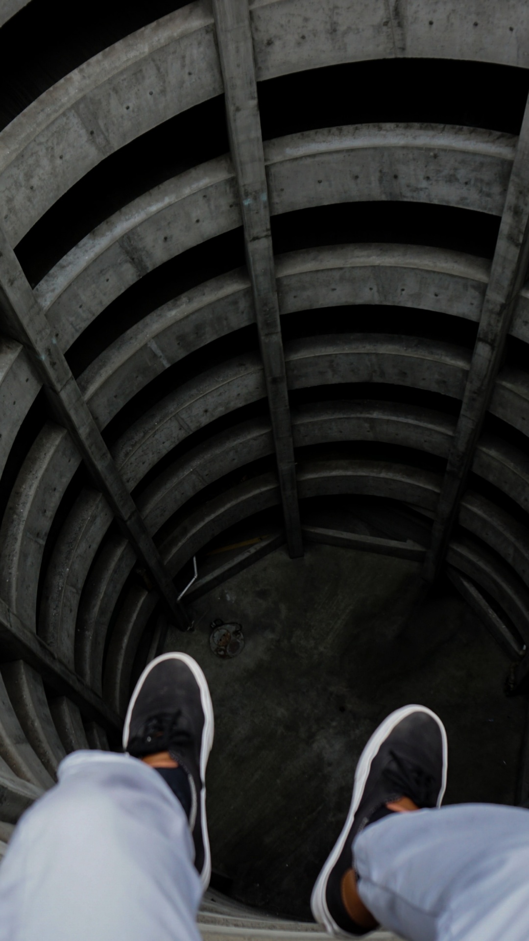 Person in Blue Denim Jeans and Black Shoes Sitting on Tunnel. Wallpaper in 1080x1920 Resolution
