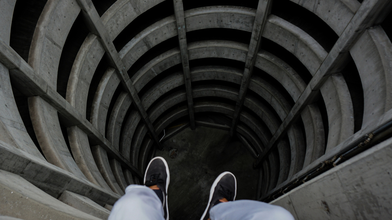 Person in Blue Denim Jeans and Black Shoes Sitting on Tunnel. Wallpaper in 1280x720 Resolution