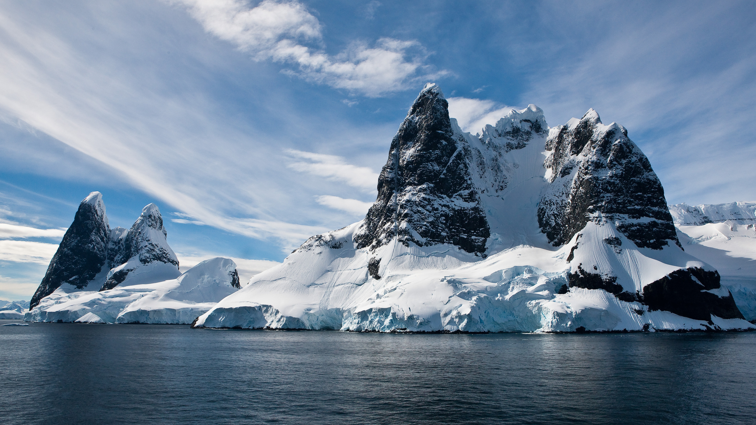 Snow Covered Mountain Near Body of Water During Daytime. Wallpaper in 2560x1440 Resolution