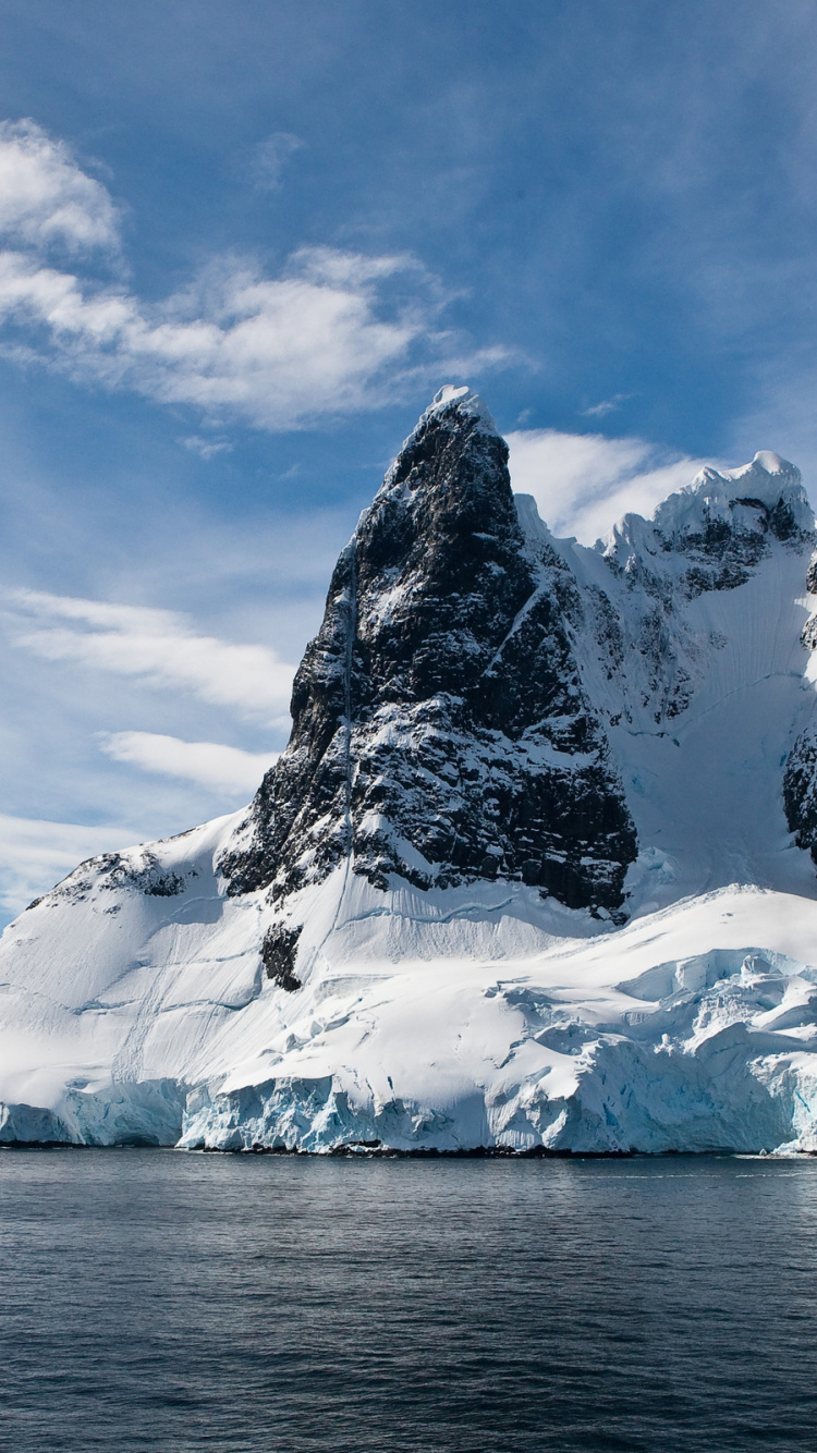 Snow Covered Mountain Near Body of Water During Daytime. Wallpaper in 750x1334 Resolution