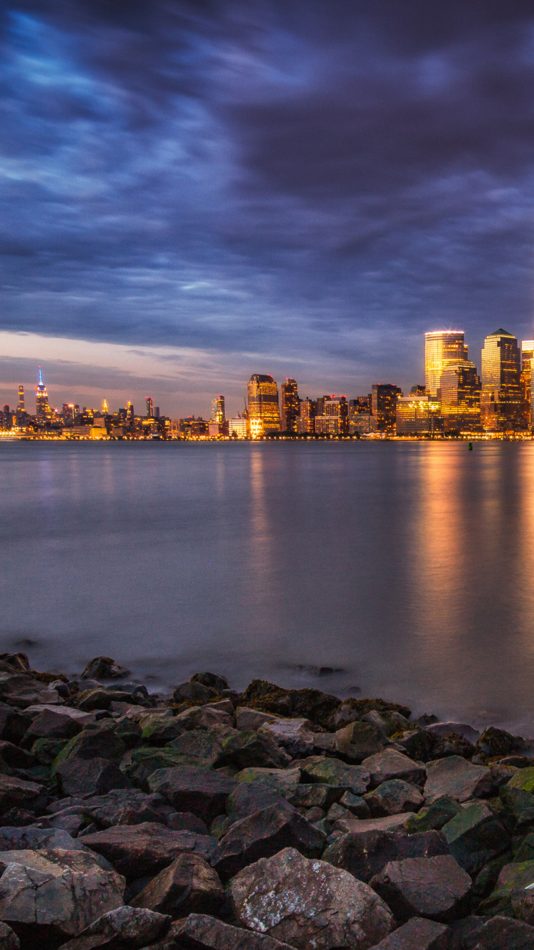 City Skyline Across Body of Water During Night Time. Wallpaper in 750x1334 Resolution