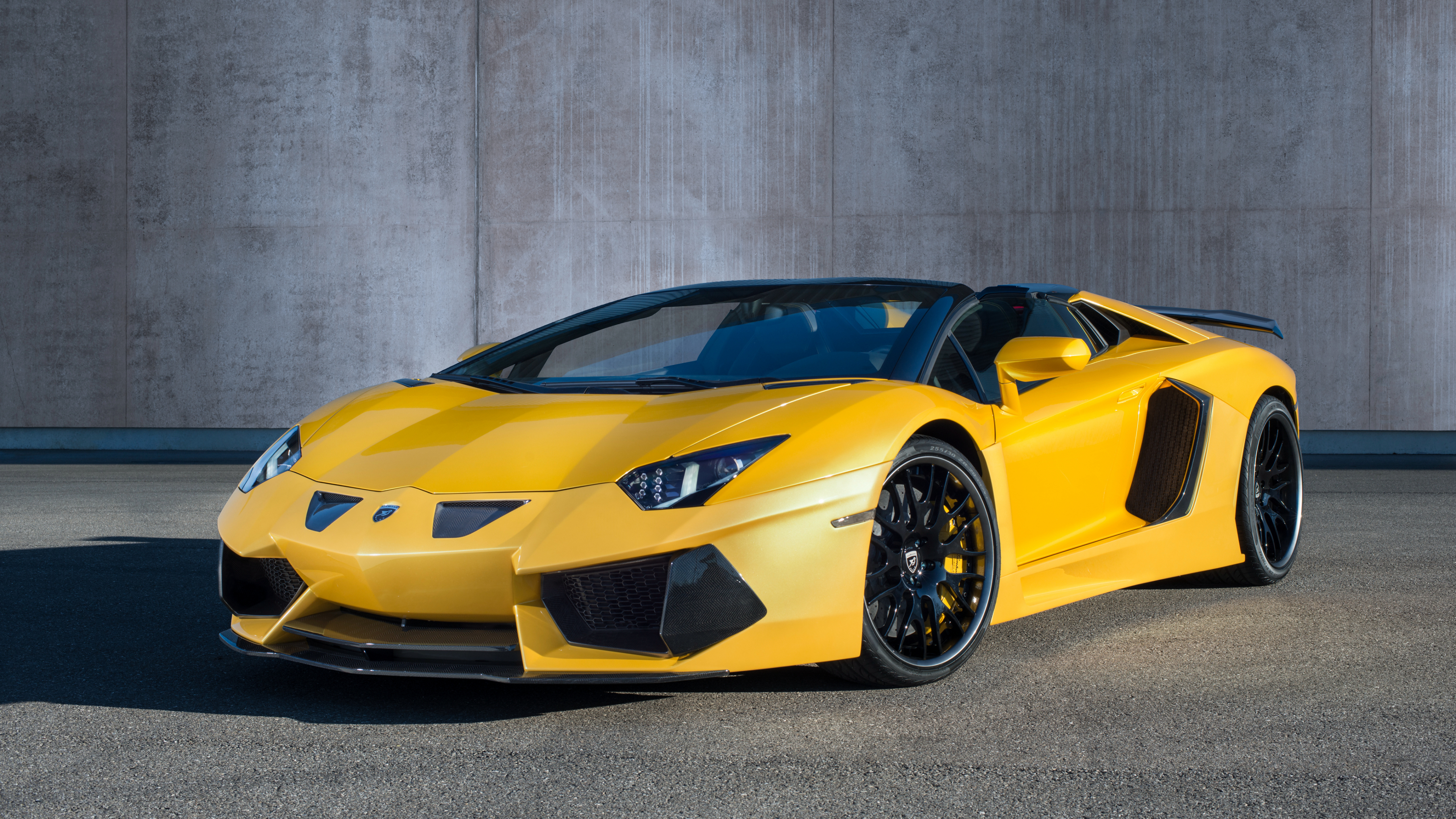 Yellow Lamborghini Aventador Parked Near Gray Wall. Wallpaper in 3840x2160 Resolution