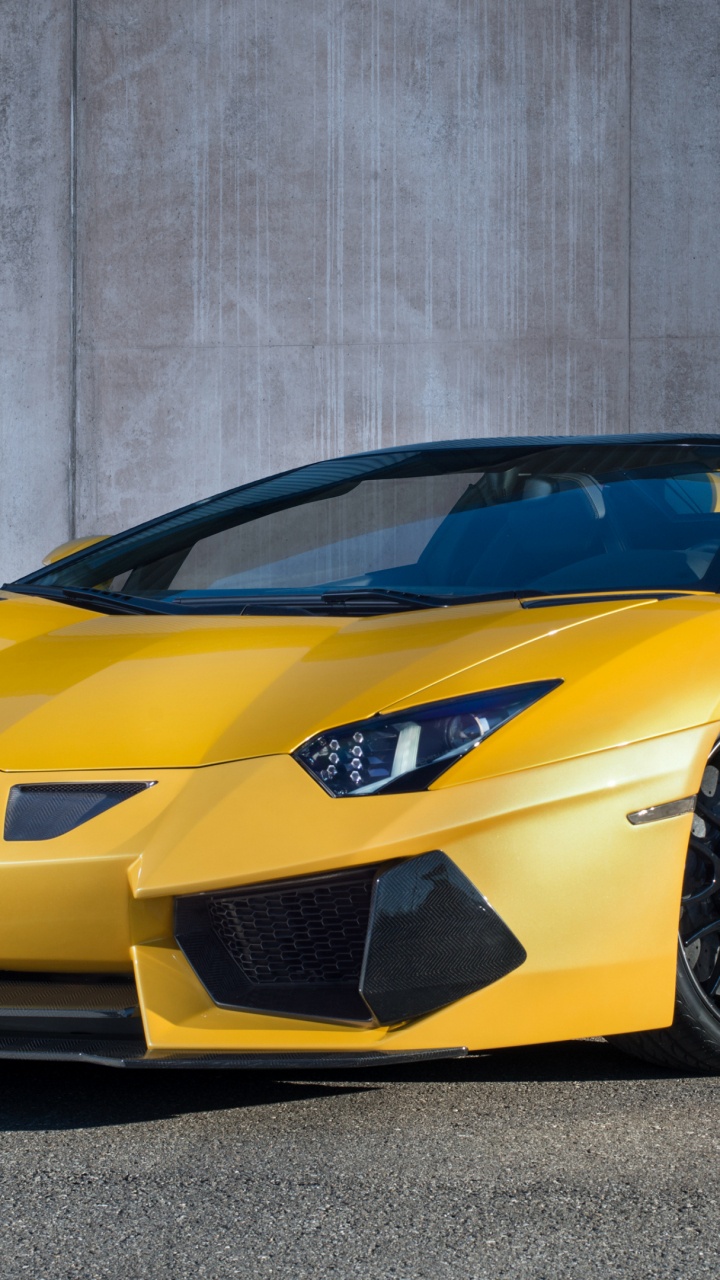 Yellow Lamborghini Aventador Parked Near Gray Wall. Wallpaper in 720x1280 Resolution