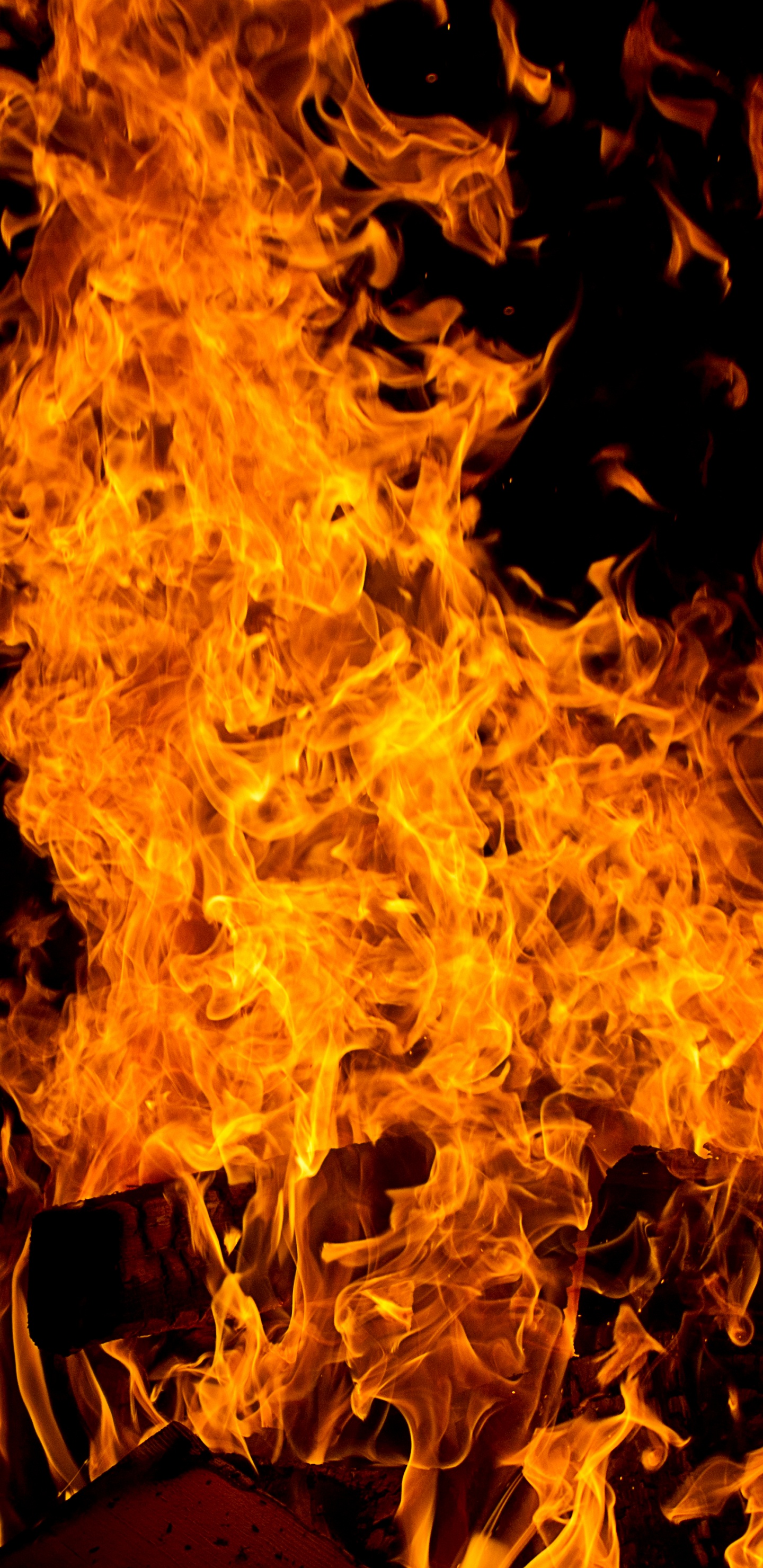 Gelbes Feuer Auf Schwarzem Hintergrund. Wallpaper in 1440x2960 Resolution