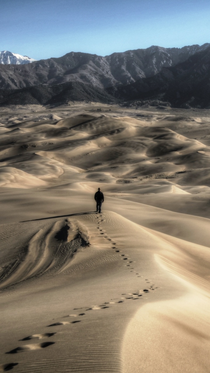 Brown Sand With Snow Covered Mountain in Distance. Wallpaper in 720x1280 Resolution