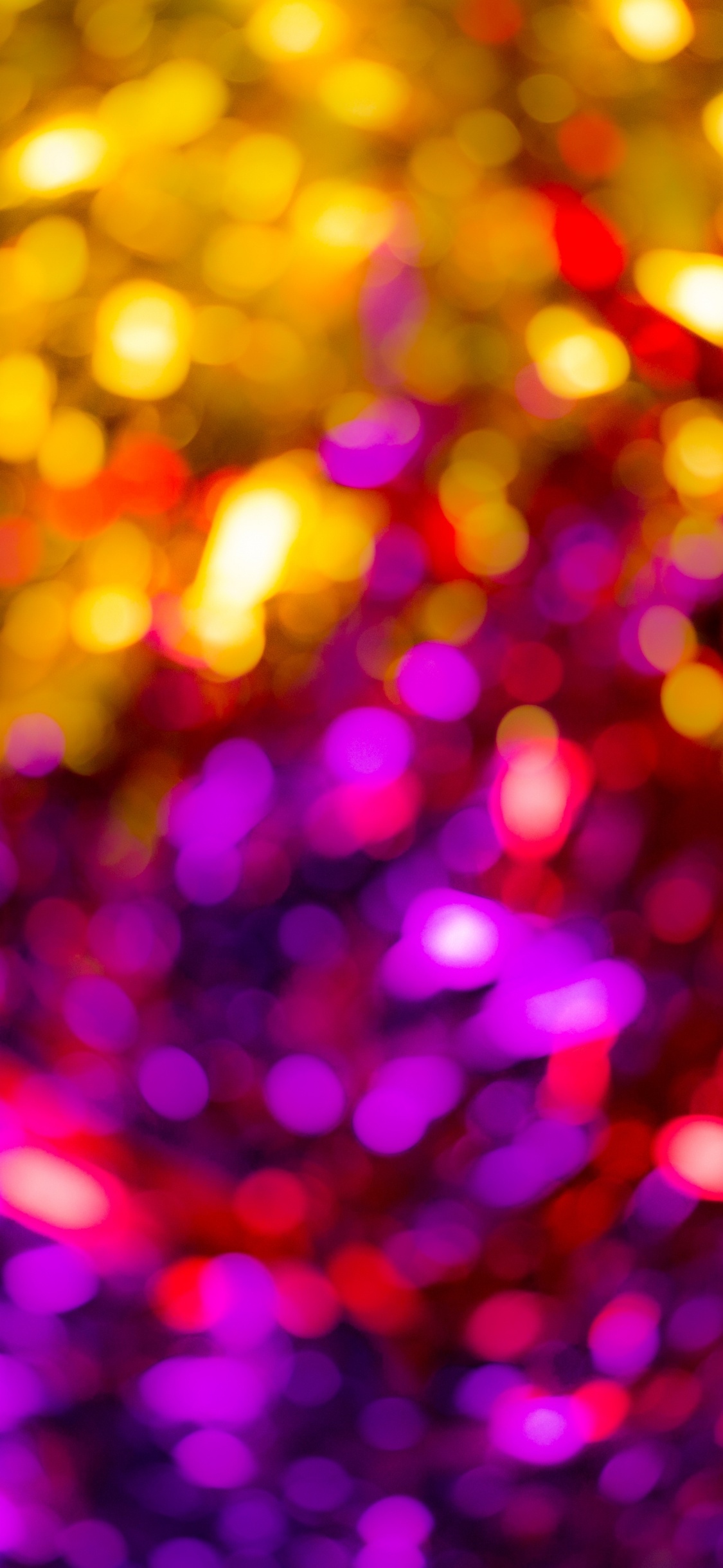 Purple and Yellow Light Bokeh. Wallpaper in 1125x2436 Resolution