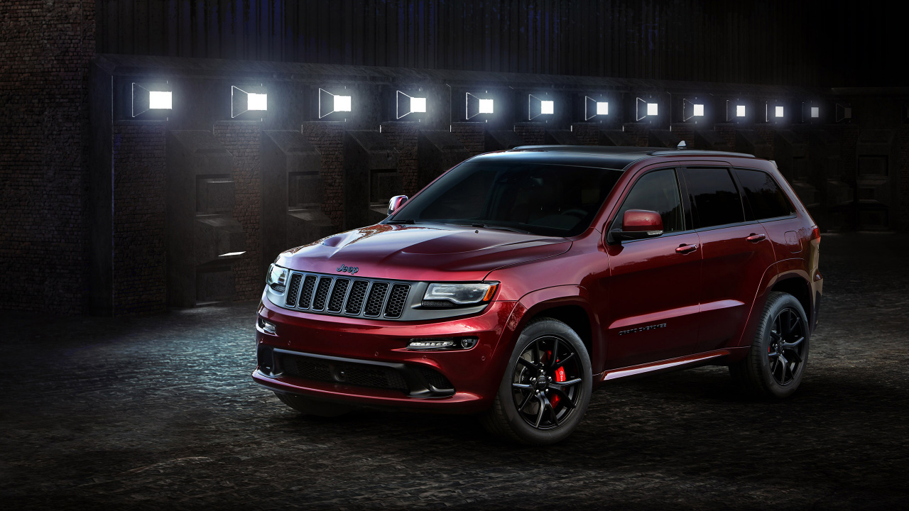 Red Ford Suv Parked Beside Brown Brick Wall. Wallpaper in 1280x720 Resolution