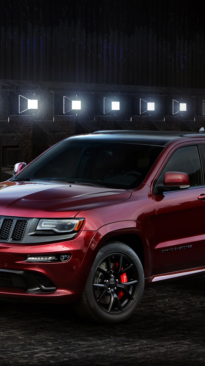 Red Ford Suv Parked Beside Brown Brick Wall. Wallpaper in 720x1280 Resolution