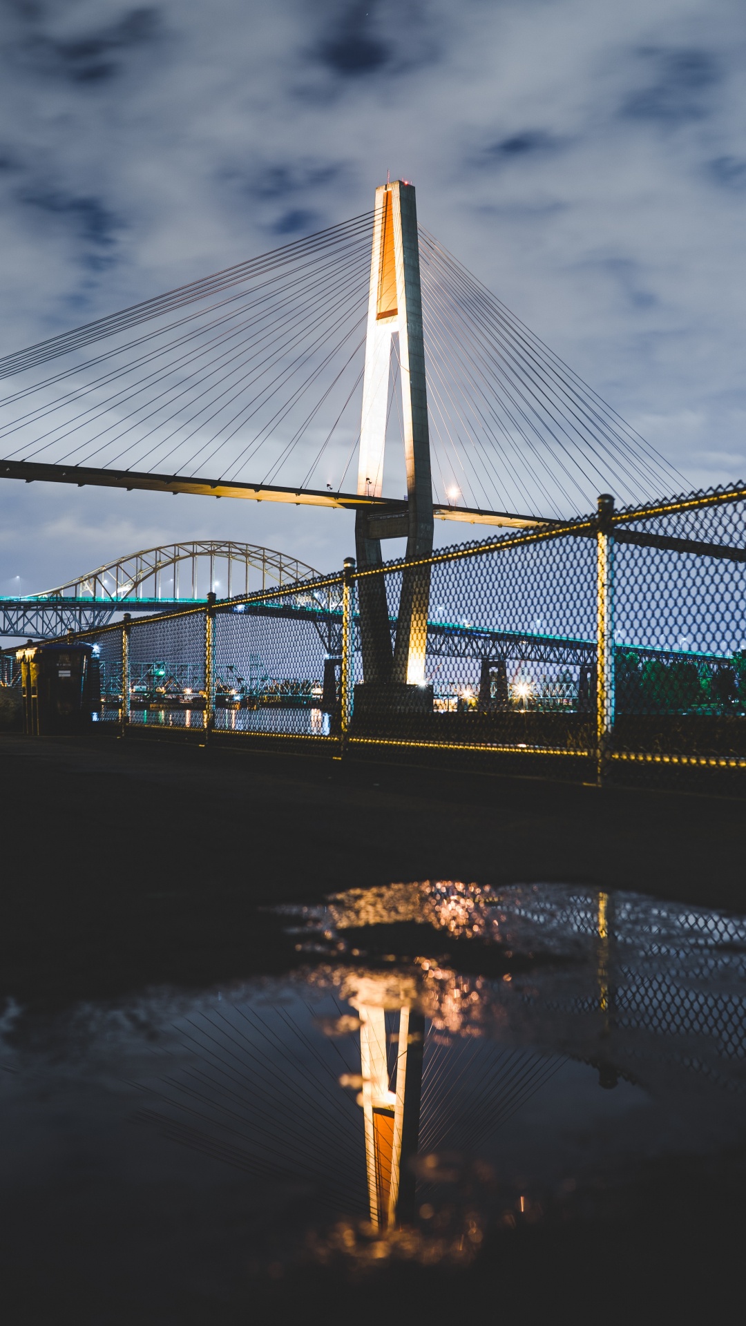 Bridge Over Water During Night Time. Wallpaper in 1080x1920 Resolution