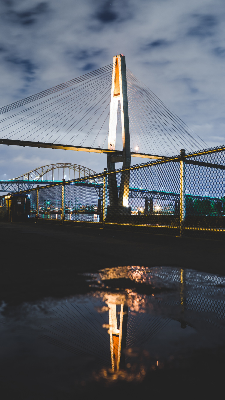 Bridge Over Water During Night Time. Wallpaper in 750x1334 Resolution