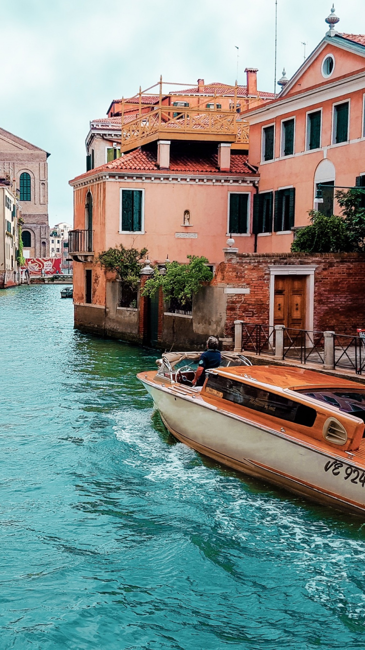 White and Brown Boat on Water Near Concrete Buildings During Daytime. Wallpaper in 750x1334 Resolution
