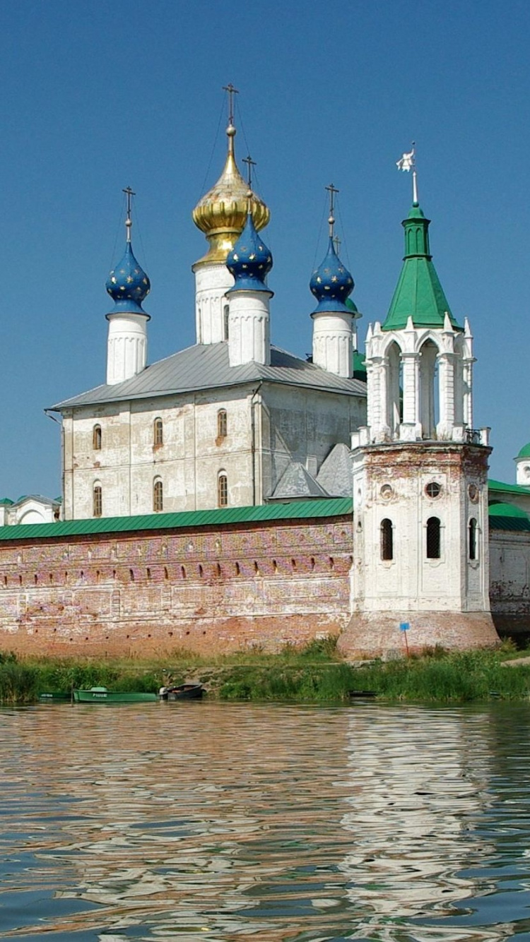 Bâtiment en Béton Blanc et Marron Près D'un Plan D'eau Pendant la Journée. Wallpaper in 750x1334 Resolution