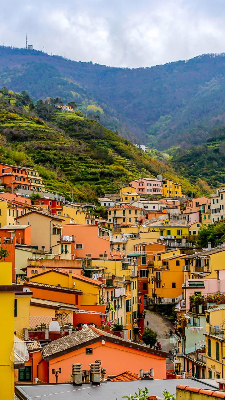 Yellow and Brown Concrete Houses Near Green Mountains During Daytime. Wallpaper in 720x1280 Resolution