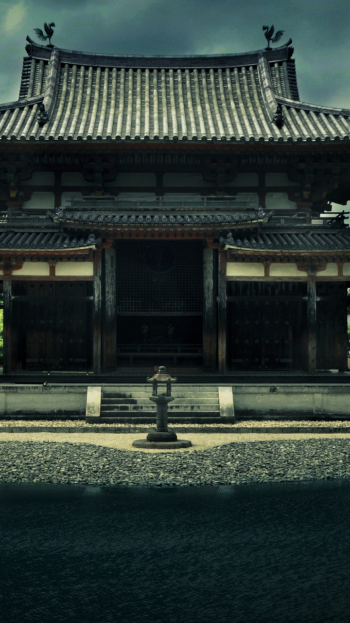 Brown and Black Temple Near Body of Water During Daytime. Wallpaper in 720x1280 Resolution