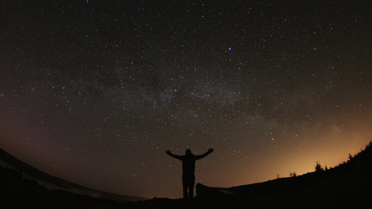 Silhouette of Person Standing on Hill Under Starry Night. Wallpaper in 1280x720 Resolution