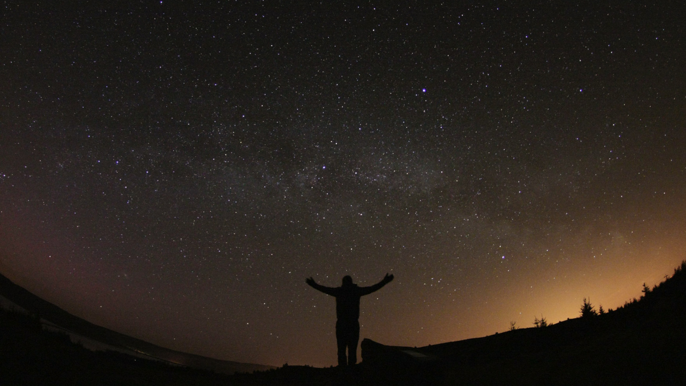 Silhouette of Person Standing on Hill Under Starry Night. Wallpaper in 1366x768 Resolution