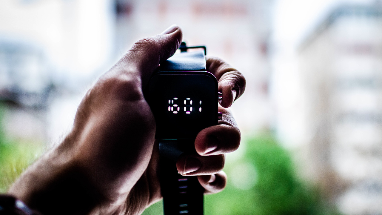 Person Holding Black Digital Device. Wallpaper in 1280x720 Resolution