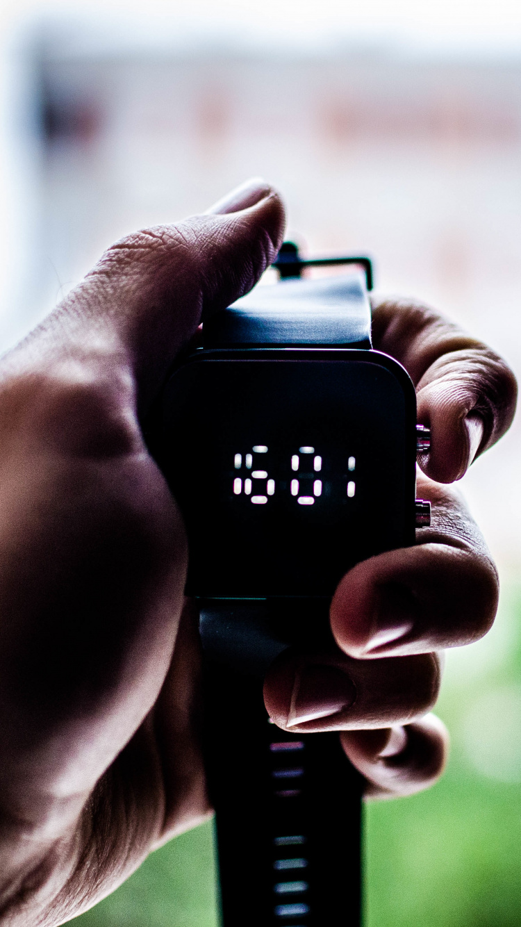 Person Holding Black Digital Device. Wallpaper in 750x1334 Resolution