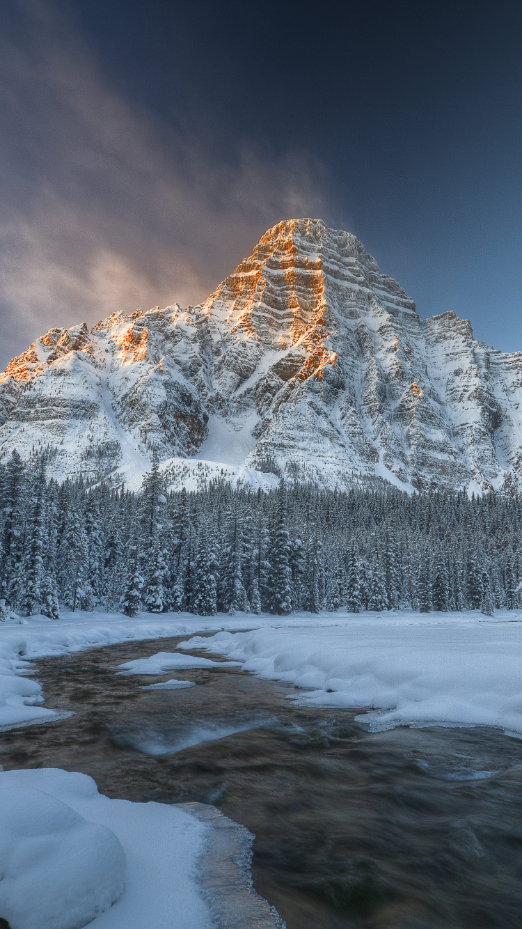 Snow Covered Mountain Under Blue Sky. Wallpaper in 750x1334 Resolution