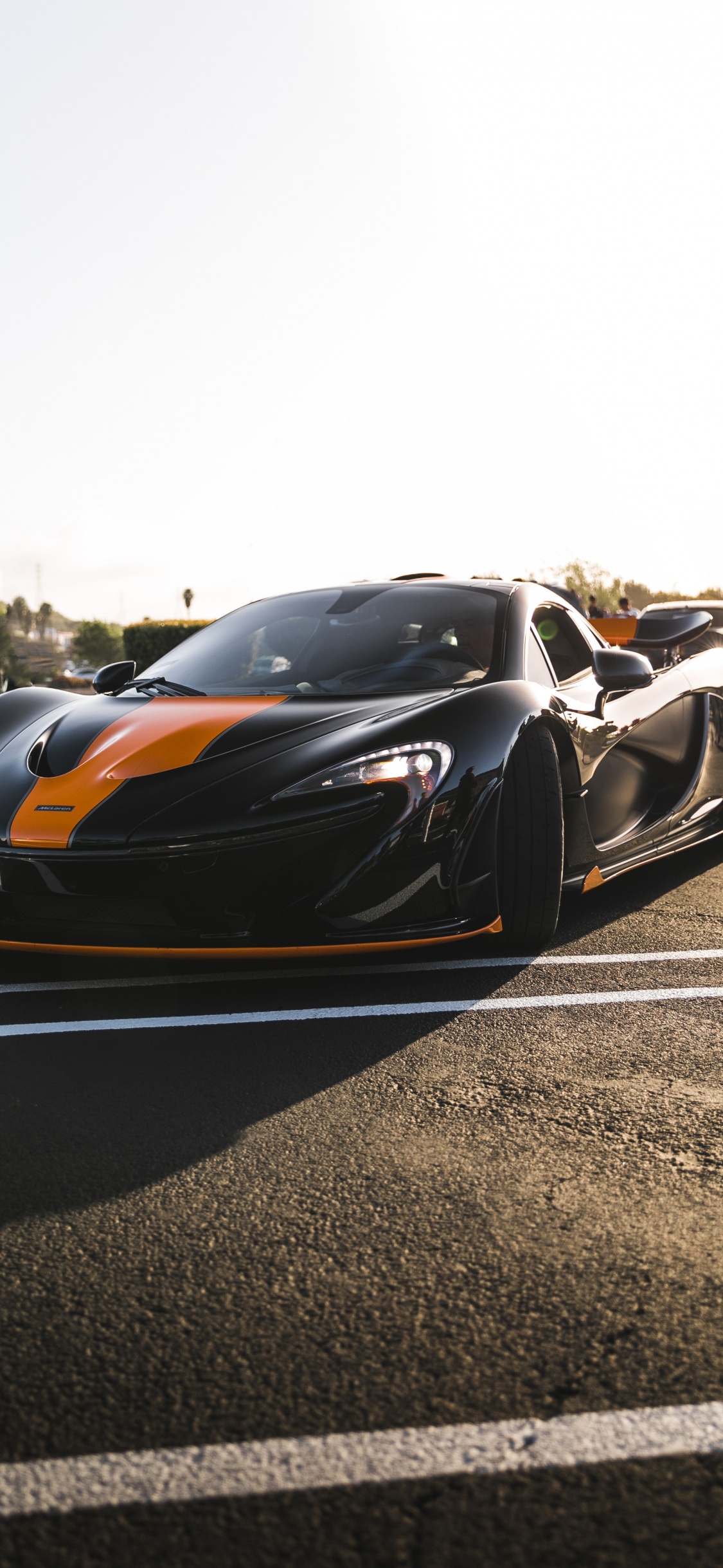 Black and Orange Sports Car on Road During Daytime. Wallpaper in 1125x2436 Resolution