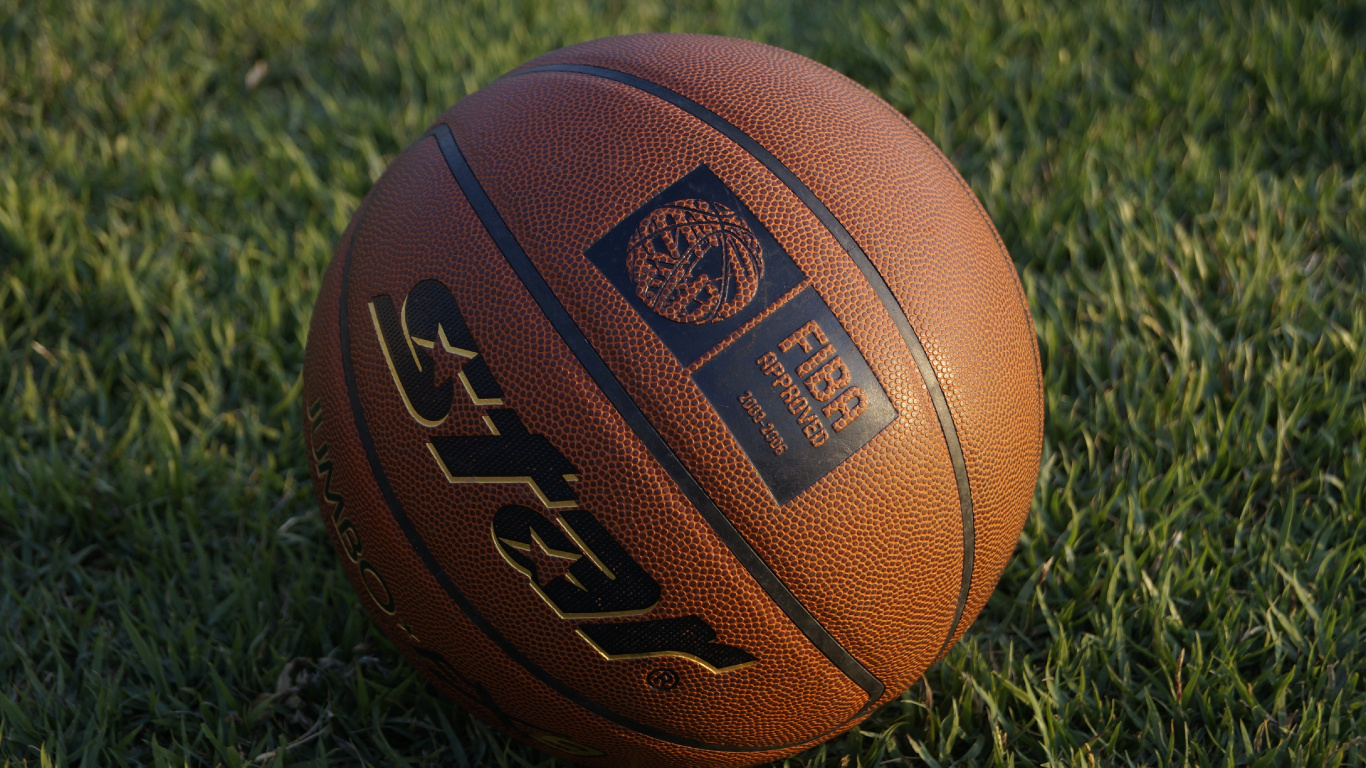 Brown Basketball on Green Grass. Wallpaper in 1366x768 Resolution