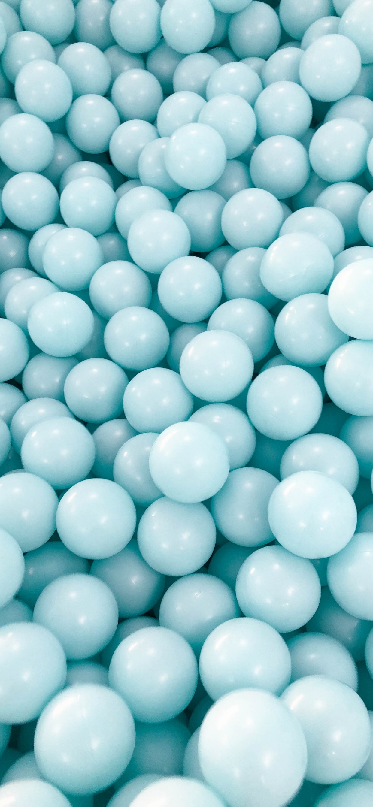 Green Round Beads on White Plastic Container. Wallpaper in 1242x2688 Resolution