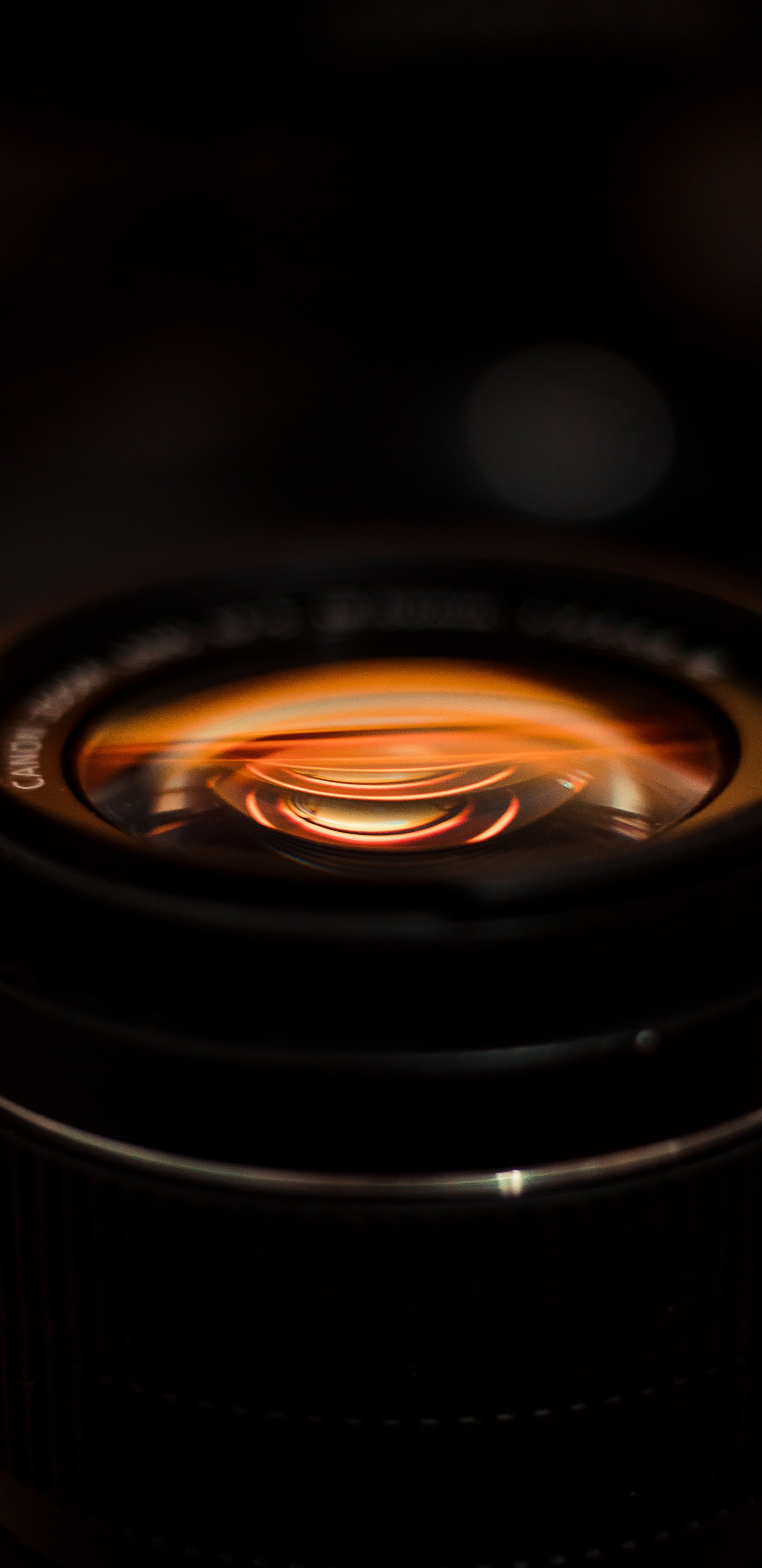 Black Camera Lens With Orange Light. Wallpaper in 1440x2960 Resolution
