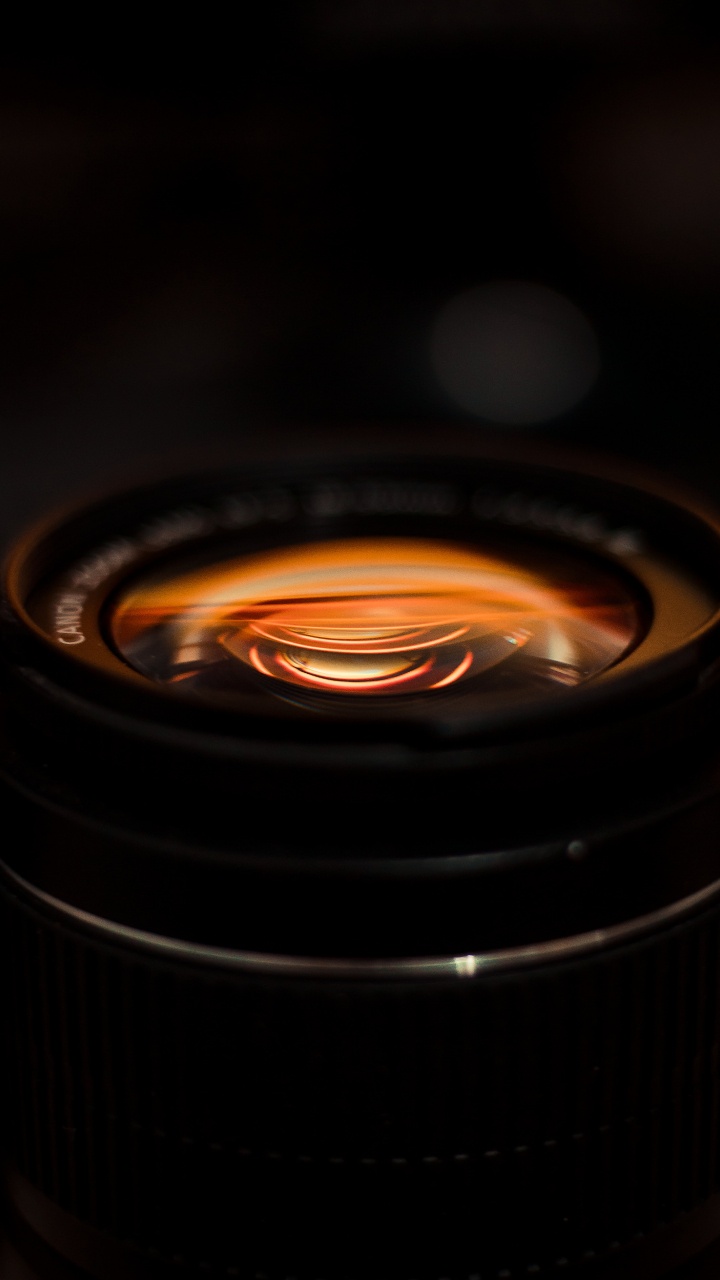 Black Camera Lens With Orange Light. Wallpaper in 720x1280 Resolution