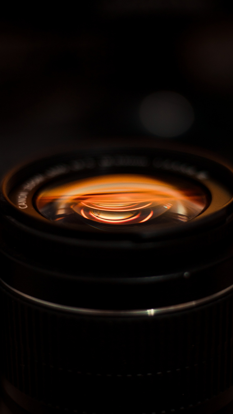 Black Camera Lens With Orange Light. Wallpaper in 750x1334 Resolution